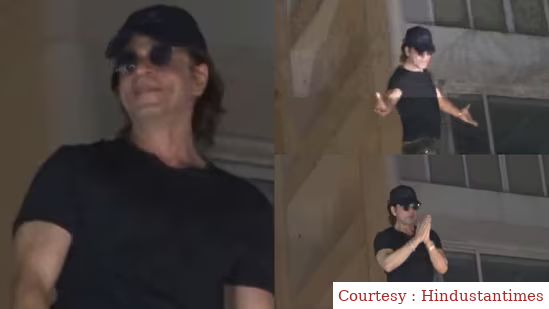 Shah Rukh Khan greets fans in a signature pose on their 58th birthday outside the Mannat